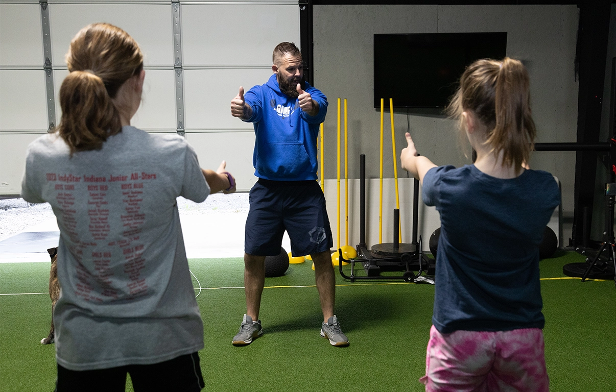 Youth athletes receiving feedback from Alex Makin at Alex Makin Performance.