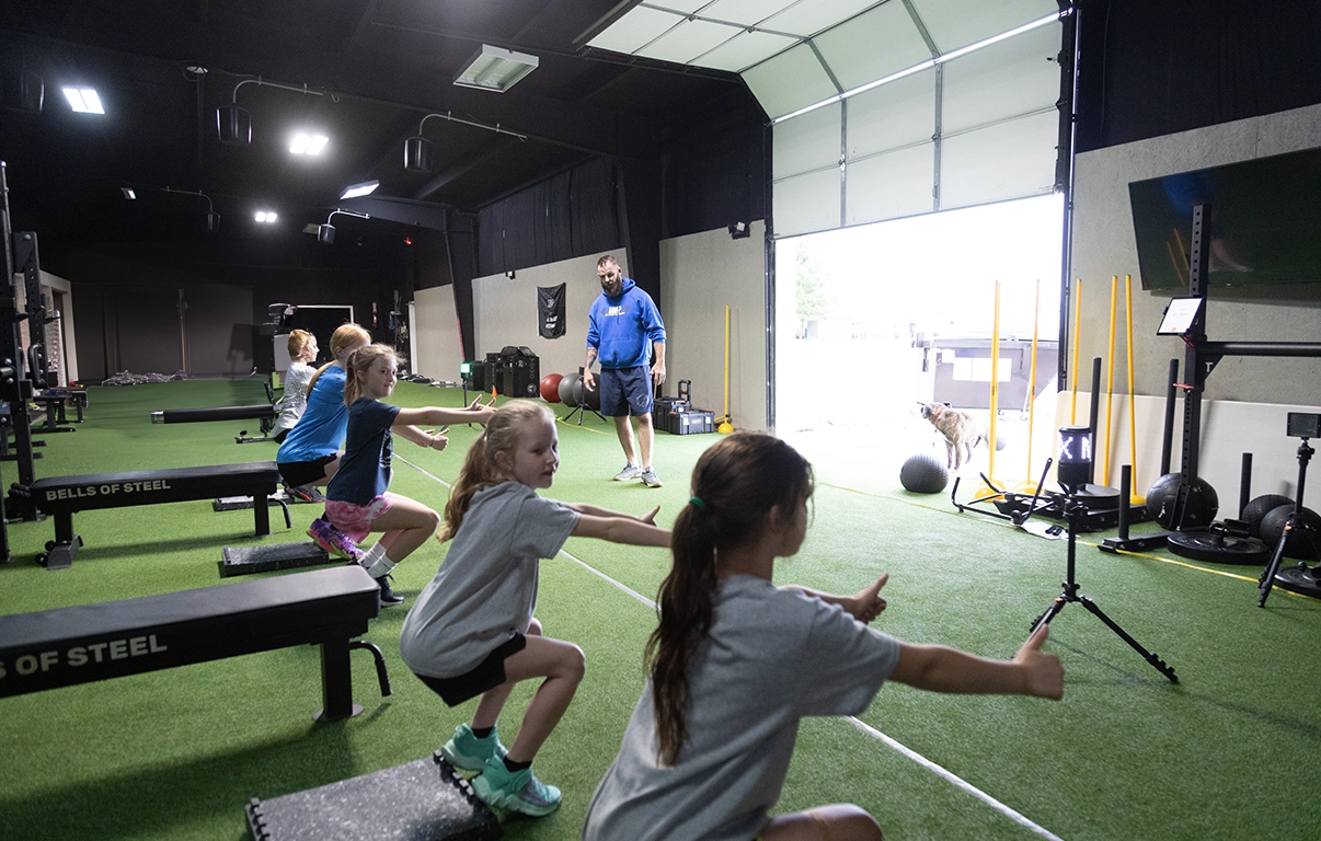 Young athletes practicing squats at Alex Makin Performance