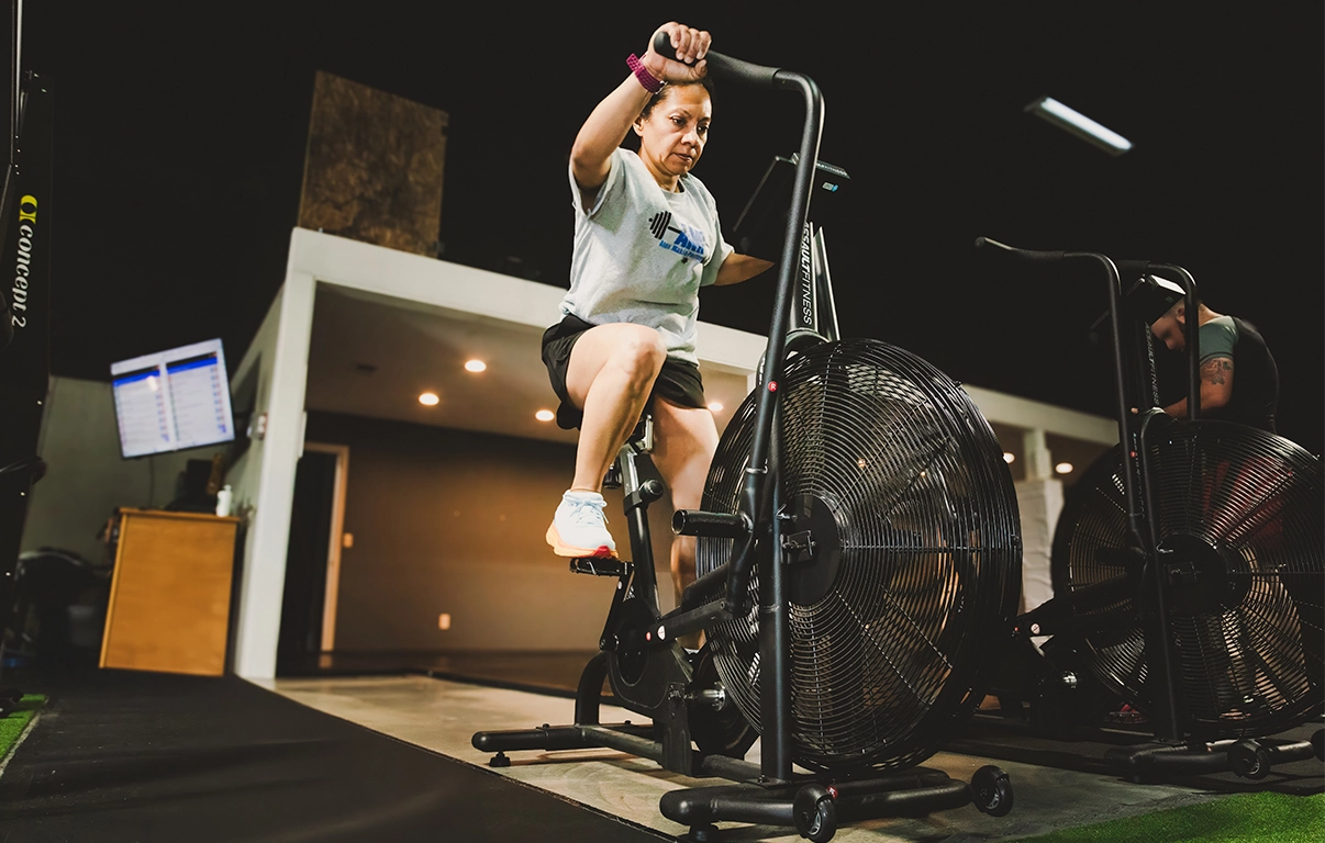 Woman riding an exercise bike for cardiovascular fitness and endurance training.