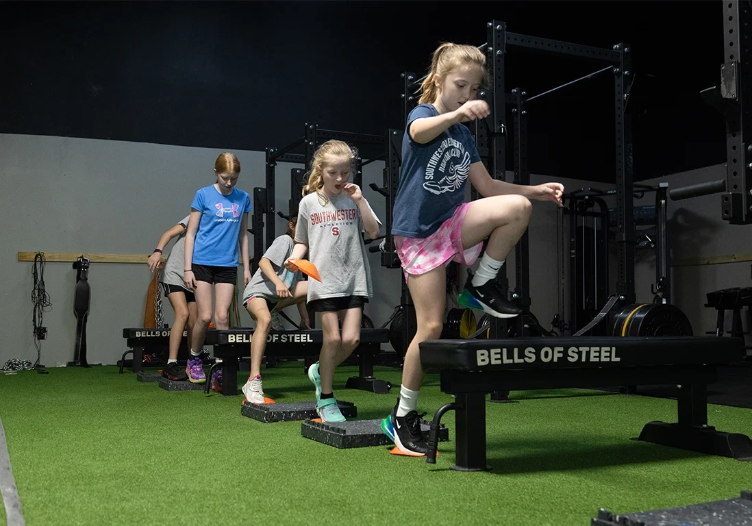 Group of young athletes participating in a fitness drill at Alex Makin Performance